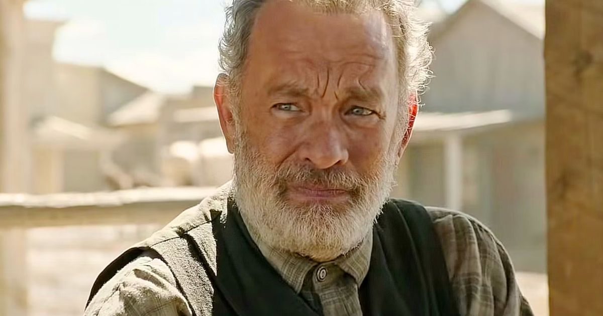 A bearded Tom Hanks from A Man Named Otto looking solemnly to the side 