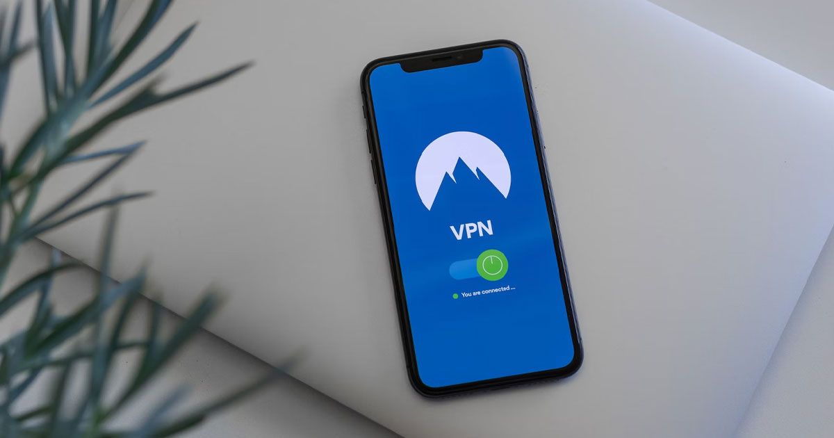 NordVPN loaded up on a black iPhone laying on a grey surface.