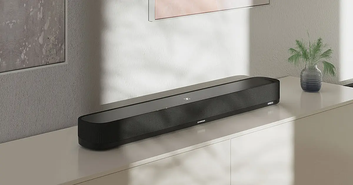 A black, rectangular-shaped soundbar with curved ends sat on a light brown cabinet.