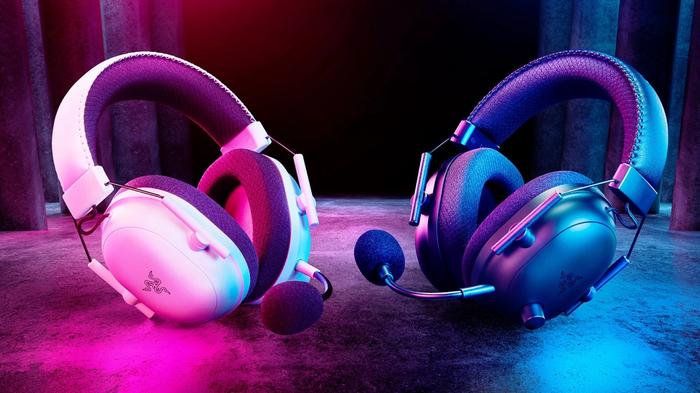 An image of a white and black pair of Razer BlackShark V2 Pro headsets on a red and blue background. 