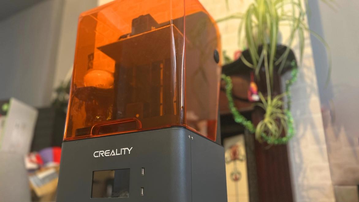 Creality HALOT-MAGE Pro Review - 3D printer sitting on a table next to a plant 