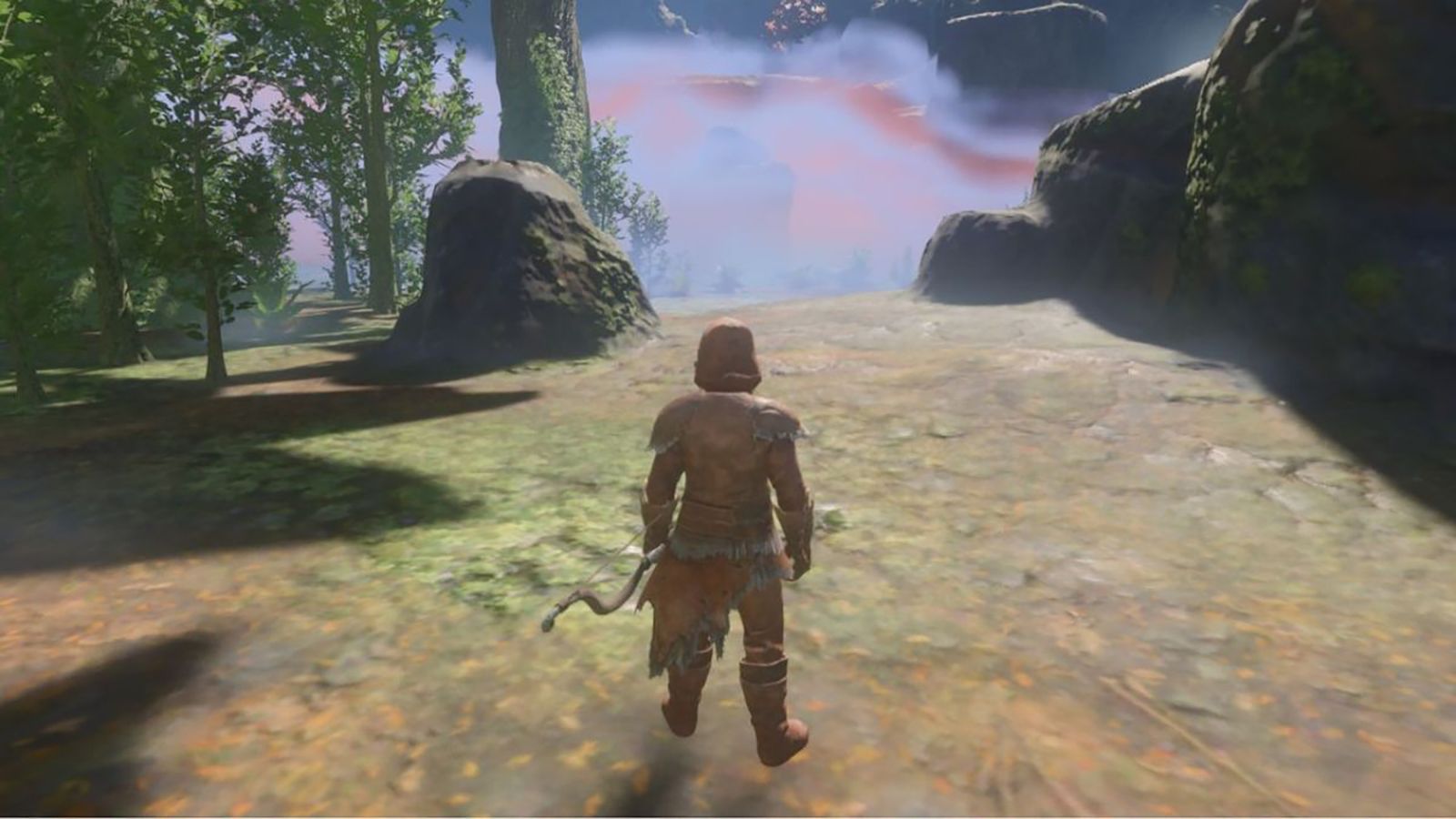 Enshrouded player standing in grass with rocks and trees in background