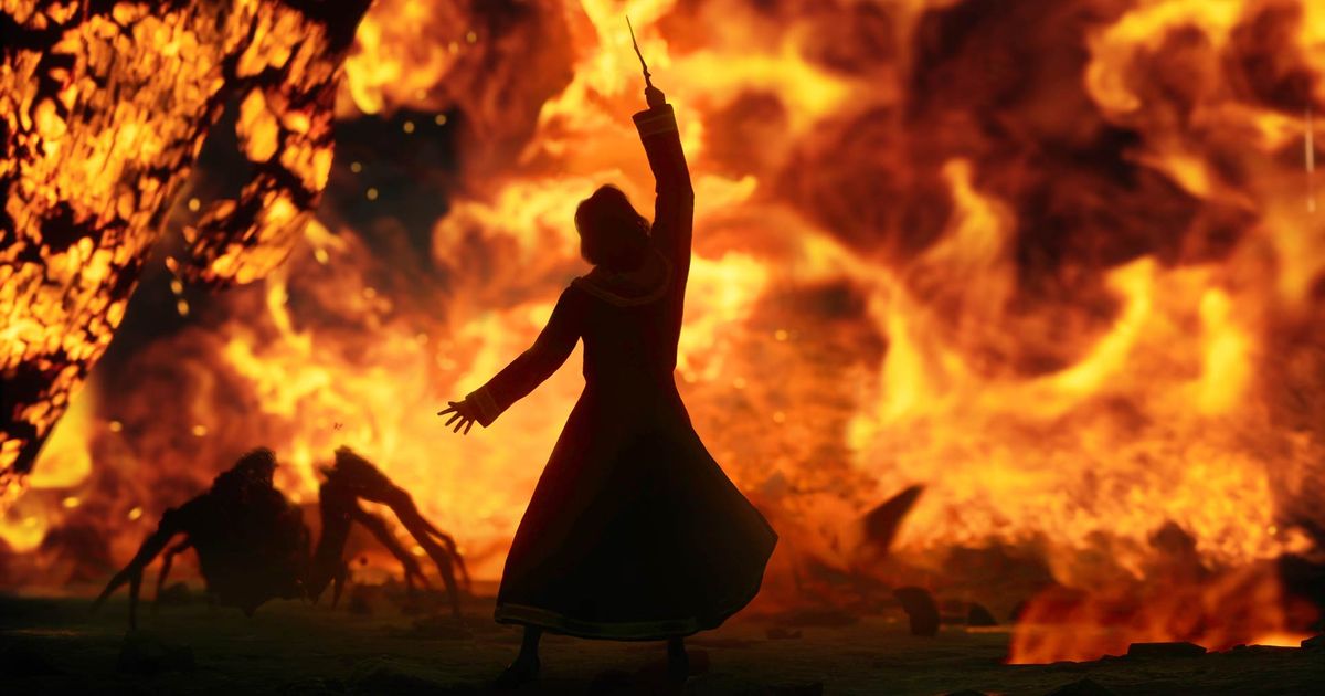 A wizard in silhouette, with wand raised, as fire blazes - Hogwarts legacy release date
