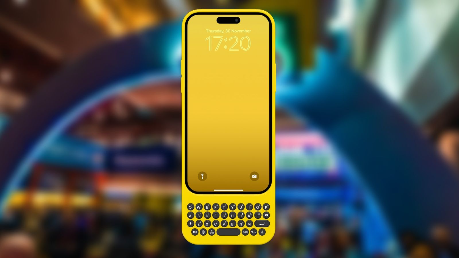 Yellow Clicks keyboard case on an iPhone in front of a blurred CES image