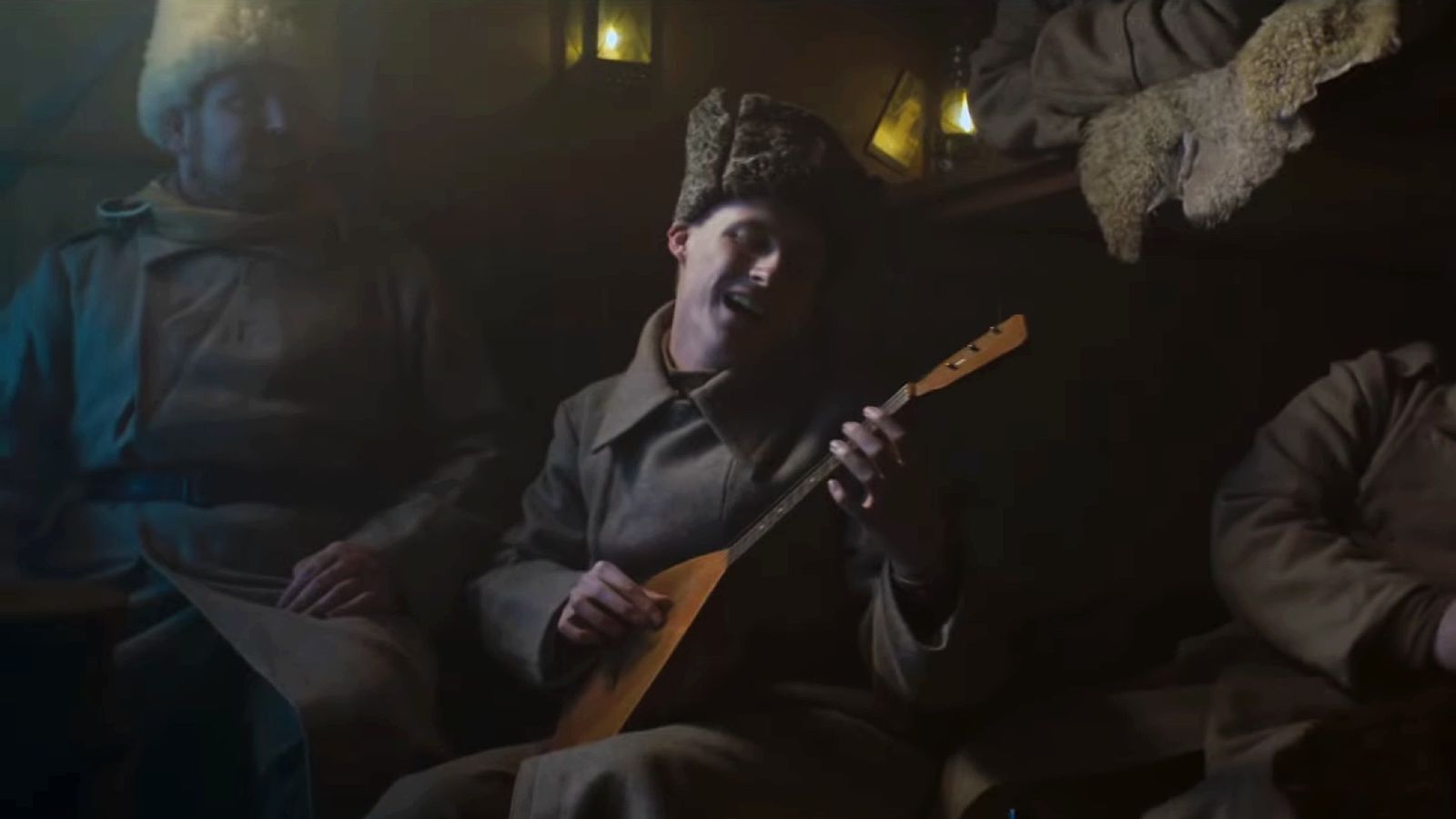 Last Train Home - soldier with guitar singing while on a train