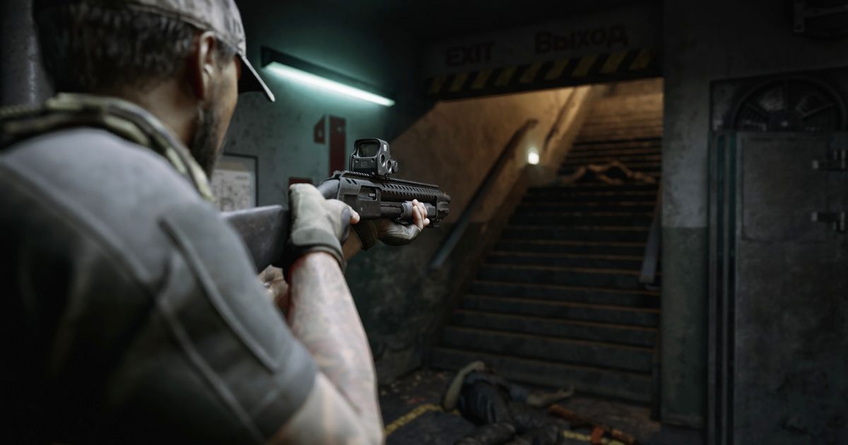A close-up shot of a soldier holding a shotgun and aiming at a dark stairwell.