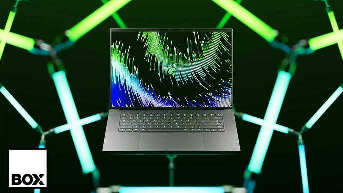 A Razer gaming laptop with a 16:10 screen against neon green and blue lights, with a Box.co.uk logo in the left corner