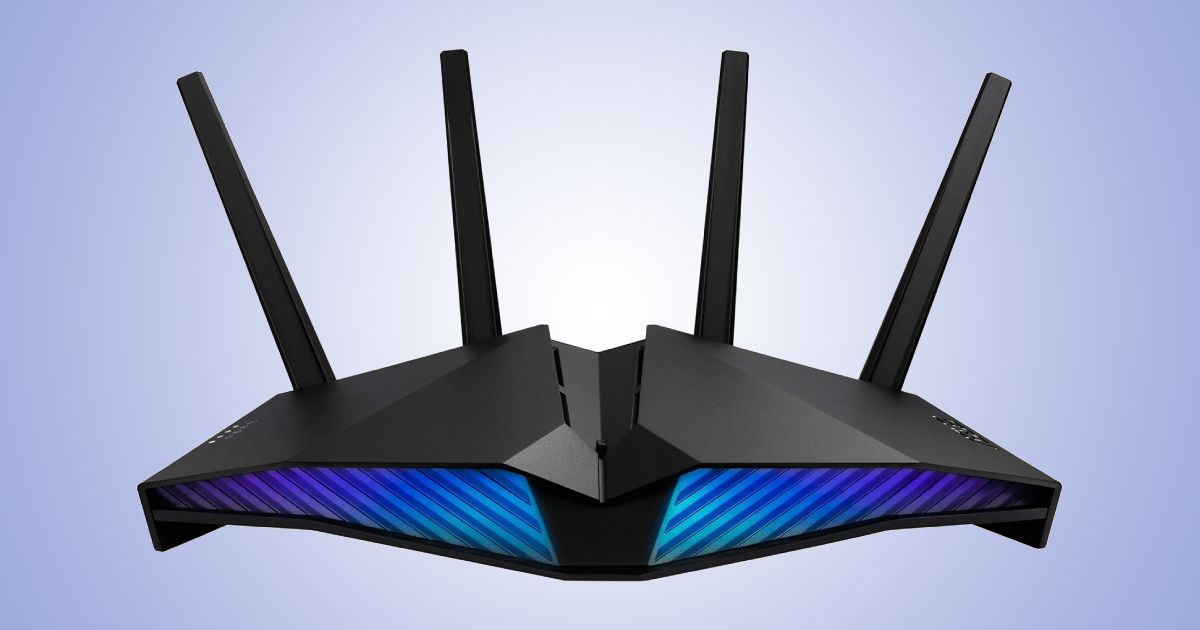 A black WiFi router featuring blue lighting and four antennae out the back in front of a gradient white and light blue background.