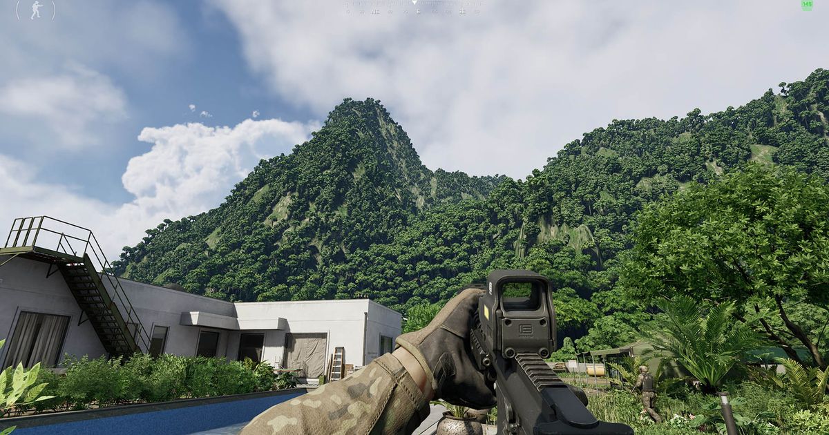 Gray Zone Warfare player holding weapon with building and tree covered mountain in background
