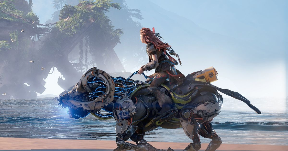 Aloy riding a machine on the coast in Horizon Forbidden West press image