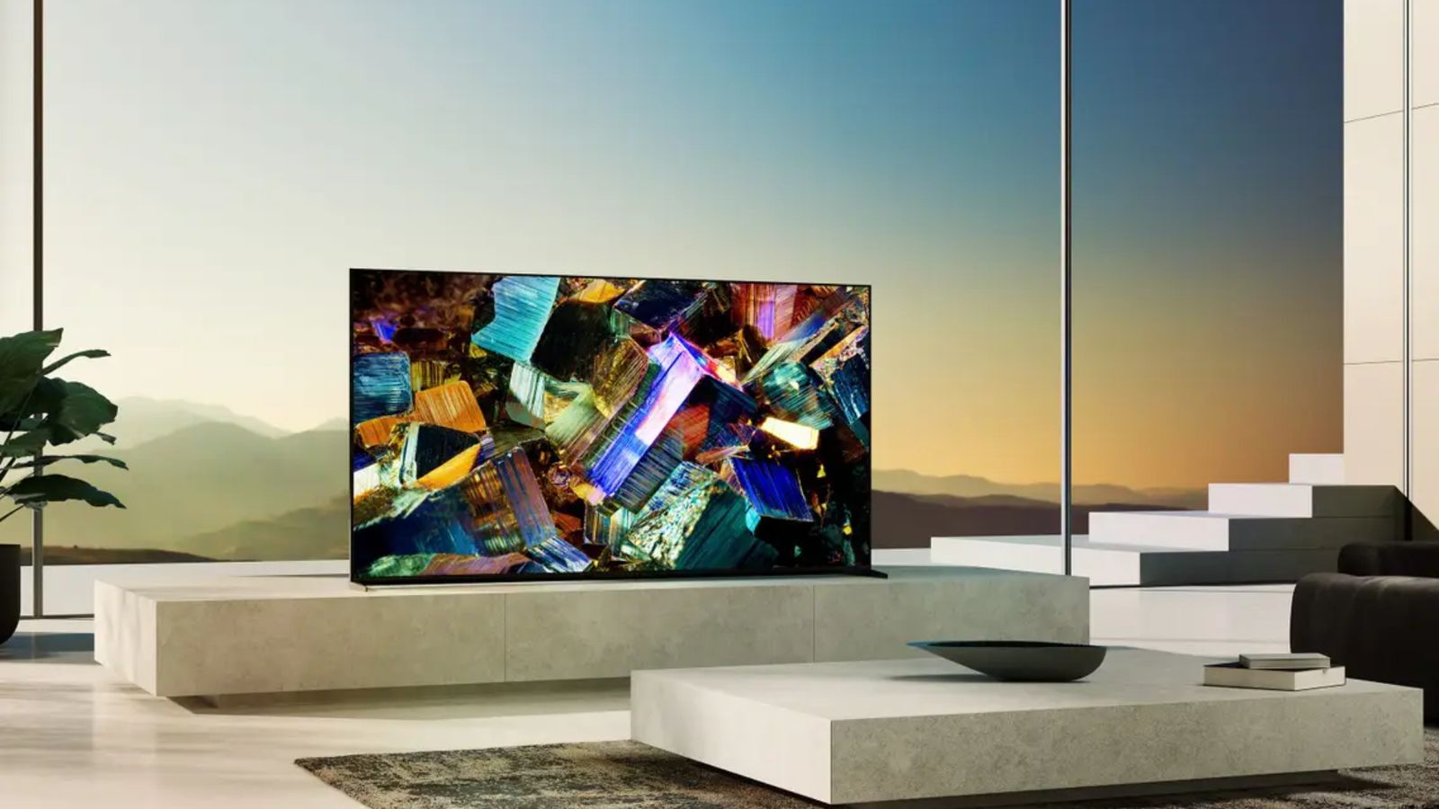 Image of a TV in a living room in front of a large floor-to-ceiling window featuring crystalised rocks on the display.