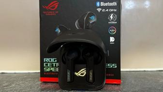 ASUS ROG Cetra earbuds inside the case in front of the box