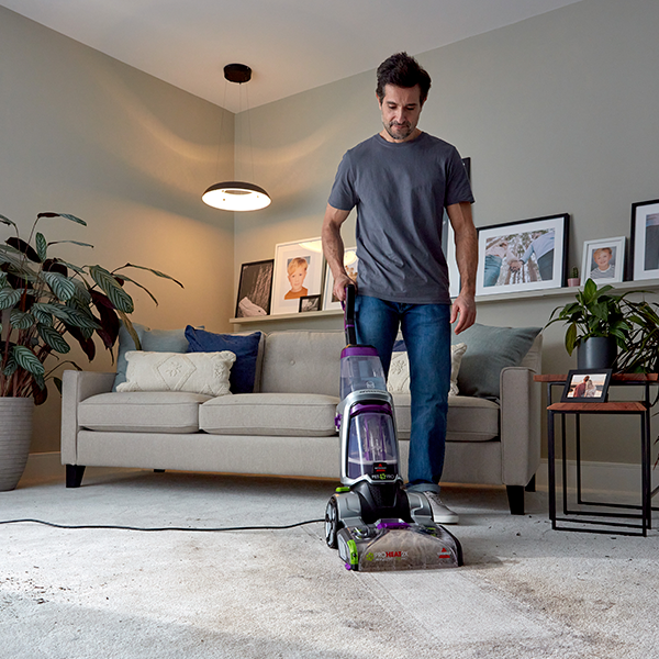Man cleaning his carpet - how often should you clean your carpet