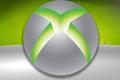 The Xbox 360 logo towering over a green and grey wallpaper background 