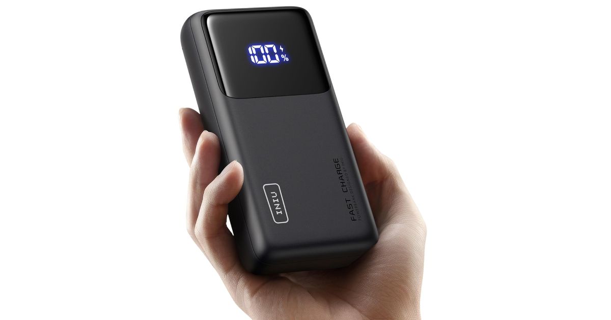 Iniu Power Bank product image of a black power bank with a digital display held in somebody's hand.