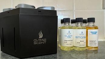 Gamescent AI diffuser next to six different Gamescent bottles