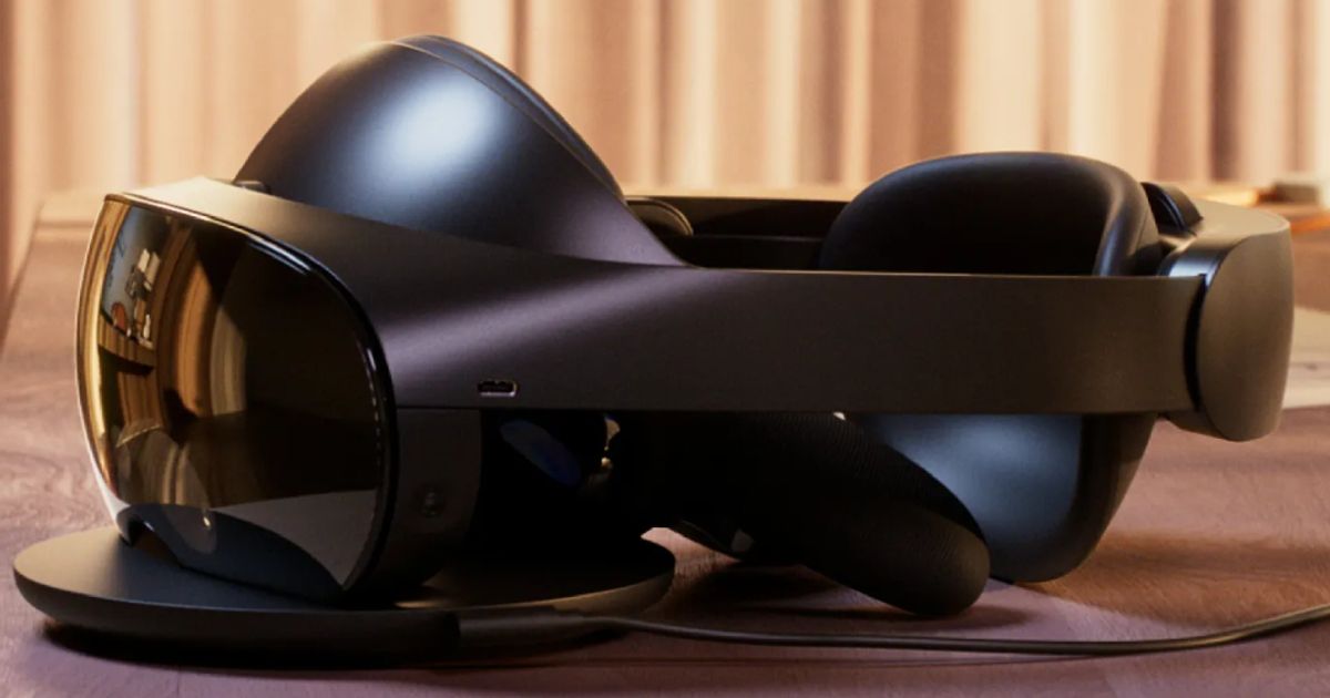 A black VR headset with a cushioned back sat on a charging dock.