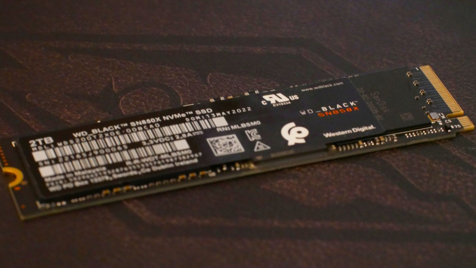 a close-up shot of a Western Digital WD Black SN850X SSD resting on top of an Elder Scrolls background 